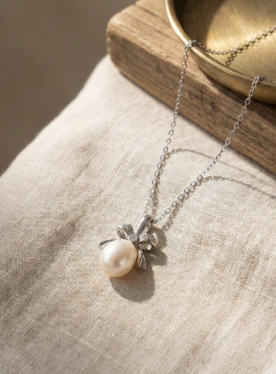 Teardrop Pearl Bow Pendant Necklace with Shimmering Zircons – Silver Tone