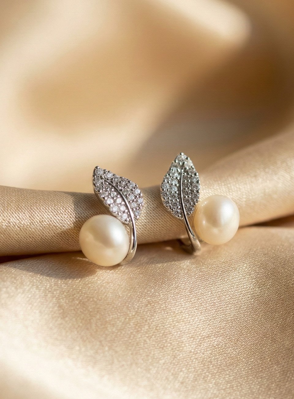 Elegant Leaf-Motif Pearl Stud Earrings with Sparkling Accents